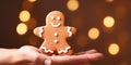 hand holding christmas gingerbreadman on the blured background, copy space, poster