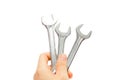 Hand holding a chrome open - end wrench spanner Royalty Free Stock Photo