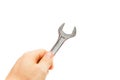 Hand holding a chrome open - end wrench spanner. Royalty Free Stock Photo