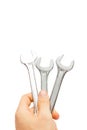 Hand holding a chrome open - end wrench spanner Royalty Free Stock Photo