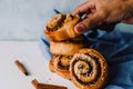 Hand holding cinnamon rolls on a white background Royalty Free Stock Photo