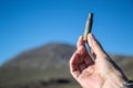 Hand holding a civil war firearm bullet case found in Sierra Nevada with blue sky background Royalty Free Stock Photo