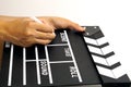 The hand is holding clapper board or movie slate black color and marker pen. Royalty Free Stock Photo