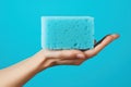 Hand holding a cleaning sponge. Generative AI