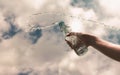 Hand holding a clear plastic bottle of pure drinking water refreshing and splash on a hot background with a hungry and thirsty