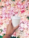 Hand holding coffee with flower background Royalty Free Stock Photo