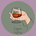 Hand holding a cognac glass