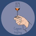 Hand holding a cognac glass