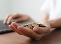 Hand holding coins on stack on table. concept saving money and financial growth