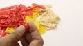 Hand holding colorful crackers or krupuk unfired isolated Royalty Free Stock Photo