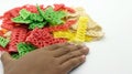 Hand holding colorful crackers or krupuk unfired isolated Royalty Free Stock Photo