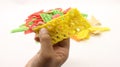 Hand holding colorful crackers or krupuk unfired isolated Royalty Free Stock Photo