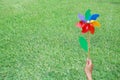 Hand holding colorful pinwheel in the garden Royalty Free Stock Photo