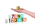 Hand holding colorful plastic numbers on white background ,No1 Royalty Free Stock Photo