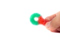 Hand holding a colorful sugar coated chewy gummy candy in white background