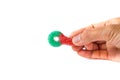 Hand holding a colorful sugar coated chewy gummy candy in white background