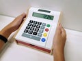 Hand Holding Colorful Toy Cash Register with Number Buttons and Display Royalty Free Stock Photo