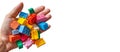 hand holding colorful toy plastics bricks, blocks for building toys on white a background Royalty Free Stock Photo