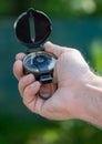 Hand holding a compass with a black cover Royalty Free Stock Photo