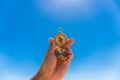 Hand holding a compass with blue sky background. summer time Royalty Free Stock Photo