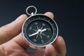 Hand holding compass, business or economy direction, world exploration or decision concept