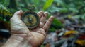 Hand Holding Compass in forest, pointing towards a direction in rainforest Royalty Free Stock Photo