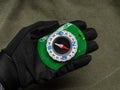 Hand in a black glove holds a compass Royalty Free Stock Photo