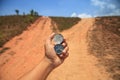 Hand holding a compass in nature. Royalty Free Stock Photo