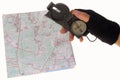Hand holding a compass over a map