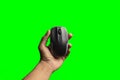 Hand holding computer mouse isolated on the green background. above view of computer mouse on green background. black and grey Royalty Free Stock Photo