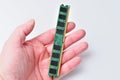 Hand holding a computer RAM module against a clean white background for tech concepts Royalty Free Stock Photo