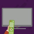 Hand Holding Computer Remote Control infront of Blank Wide Flat Color PC Screen. Creative Background Idea for Product