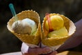 hand holding cones with ice cream