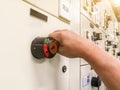 Hand holding the control panel of the industrial plant and pushing or turning the button in electrical selector switch,button Royalty Free Stock Photo