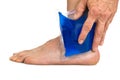 Hand holding cool gel pack on ankle Royalty Free Stock Photo