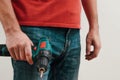 Hand holding cordless drill. Handyman with a tool screwdriwer drill