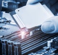 Hand holding a CPU and inserts it into the motherboard Royalty Free Stock Photo