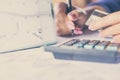 Hand holding credit card calculating her monthly expenses with deadline calendar Royalty Free Stock Photo