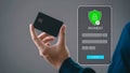 Hand holding a credit card beside a digital payment interface with shield icon and confirm button Royalty Free Stock Photo