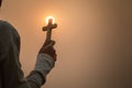 Hand holding the cross, the symbol of the blessing of Jesus, the symbol of supplication and faith, the symbol of the cross in the Royalty Free Stock Photo