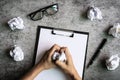 Hand holding crumpled paper balls with eye glasses and file folder on desk office Royalty Free Stock Photo