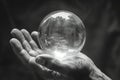 Hand holding a crystal ball evoking mystery