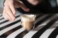 Hand holding cup of coffee on black and white background Royalty Free Stock Photo