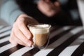 Hand holding cup of coffee on black and white background Royalty Free Stock Photo