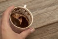 Hand holding a cup of coffee in order to fortune telling Royalty Free Stock Photo