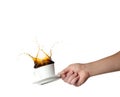 Hand holding cup with splashing coffee isolated on white background. Royalty Free Stock Photo