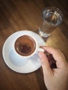 Hand holding a cup turkish coffee on table Royalty Free Stock Photo