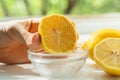 hand holding a cut slice of lemon and squeeze the fresh juice to the bowls Royalty Free Stock Photo