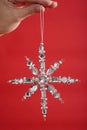 Hand holding a decorative snowflake. Conceptual image