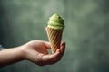 a hand holding a delectable ice cream against a vibrant backdrop Royalty Free Stock Photo